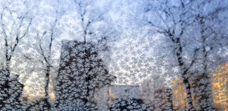 Frost patterns on the windshield of the car. The concept of changing weather and early frosts.の写真素材