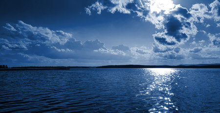 The color of the year 2020 is classic blue. Evening sunlight breaks through the curly clouds....