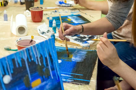 Master class in drawing. Several friends visit the painting Studio.のeditorial素材