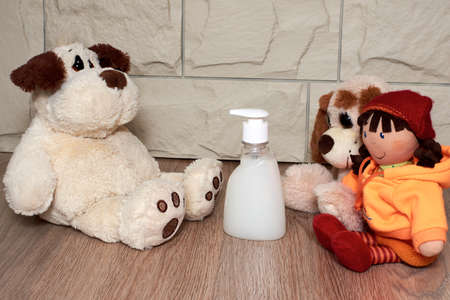 Soft toys are placed for play, liquid soap for the prevention of diseases. Concept of children's activities and entertainment in quarantine, during illnessの写真素材