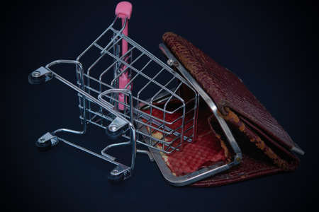 shopping cart and an empty wallet. international crisis, an abstraction of currency depreciation and...