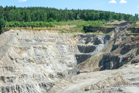 The production of graphite. industrial background. Deep quarry for the extraction of minerals.