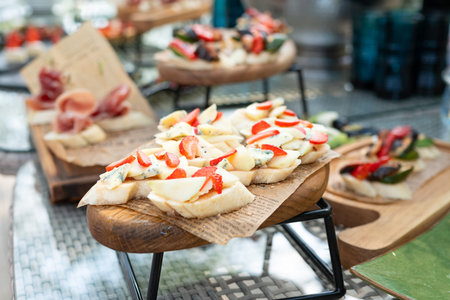 Wooden table full of appetizers and snacks for catering or party with selective focusの写真素材