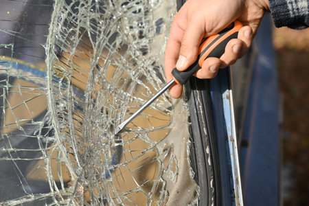 Repair of an old car that was in an accident, with broken windshieldの写真素材