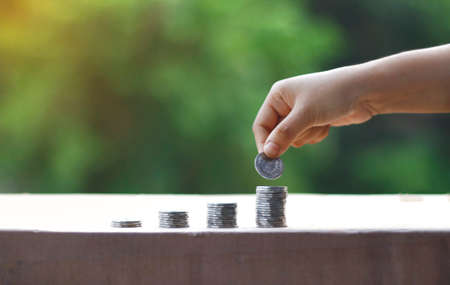 Growing Money | Business Growing. Man Holding Coin | Plant On Coins |  Finance And Investment | Profit and incomeの写真素材