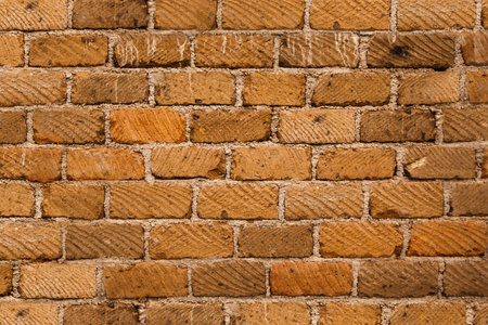 Old vintage red brick wall. Abstract blank background of horizontal brickwork of an external wall of...