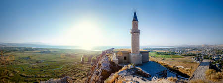 Sunset over castle of Van and Van lake with a minaret. Van castle on sunset. Fortress built during the 9th to 7th centuries BC. Turkey. Van lake in the backgroundの写真素材