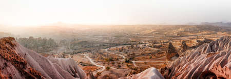 Beautiful landscape of Goreme and Uchisar castle at distance on sunrise.Cappadocia.Turkey. View of rock formations fairy chimneys, hotels and houses at the cave. Top attraction travel destinations.の写真素材