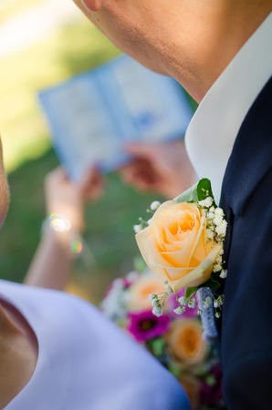 beautiful wedding boutonniere on suit of groomの写真素材