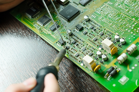 Soldering iron broken disassembled laptop.の写真素材