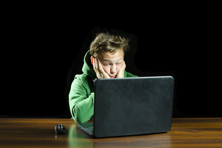 Young boy using a laptop computerの写真素材