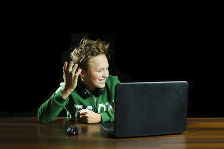 Young boy using a laptop computerの写真素材