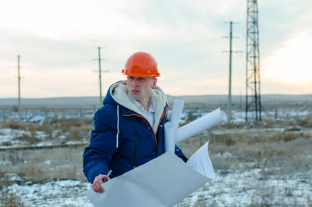 The man worker wear a orange helmet with construction site