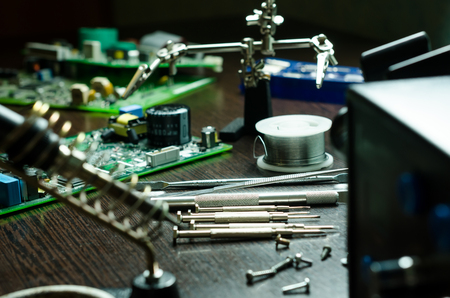 Soldering station with soft solder and tools in backgroundの写真素材