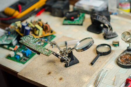 repair chip closeup. Tools, magnifier and tweezers and soldererの写真素材