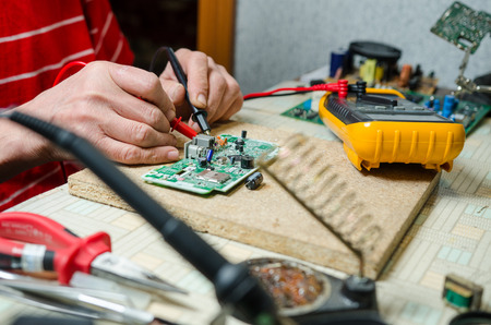 man hands closeup repair electronic device using Multimetrのeditorial素材