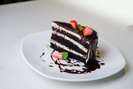 Delicious chocolate cake with strawberry on plateの写真素材