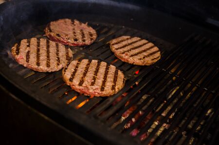 cooking burgers on hot grill. barbecue. grillingの写真素材