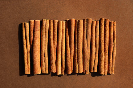 Cinnamon on brown background. Cassia sticks, alternative to real spice for dishes, coffee, cocoa....