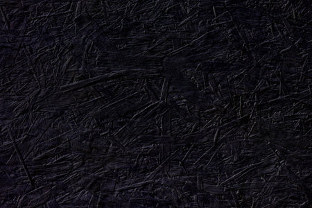 Black chipboard wall with shades of deep purple color. Horizontal background, copy space. Abstract...
