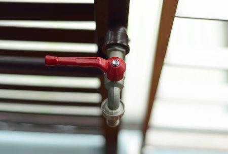 Metal tap with water dropの写真素材