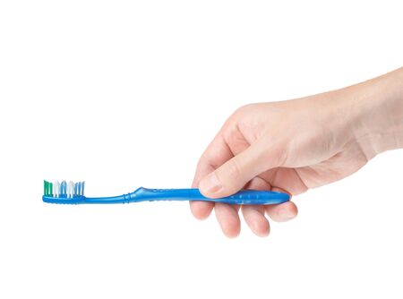 toothbrush in a male hand on a white backgroundの写真素材