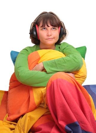 girl in bed with headphonesの写真素材