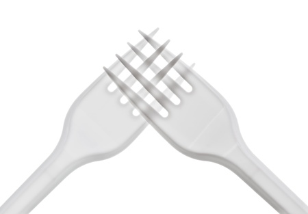 intersecting plastic forks on a white backgroundの写真素材