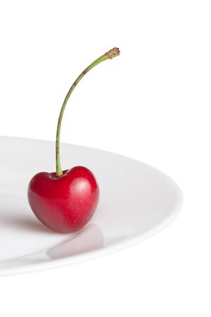 Cherry in form heart on plateの写真素材
