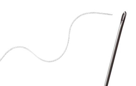 Needle and thread on a white backgroundの写真素材