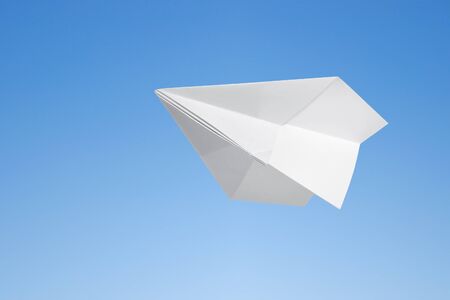 Paper airplane against the blue skyの写真素材