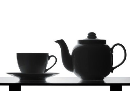 Teapot and cup on table. Silhouetteの写真素材