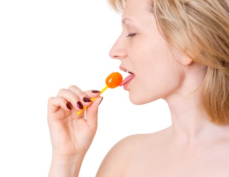 Woman licking lollipop on white background. Symbol of temptationの写真素材
