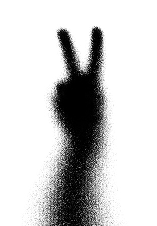 Victory. Gesture of the hand. Silhouette. Photographed through the textured glass.の写真素材