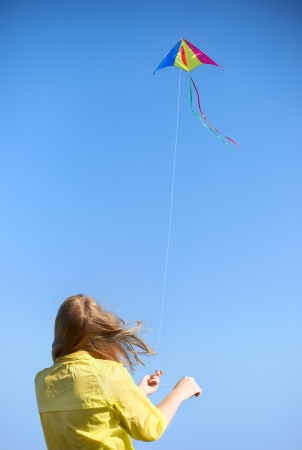 Kite on a rope against the sky  Girl keeps rope の写真素材