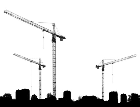Construction site with cranes and silhouettes buildings on a white backgroundの写真素材