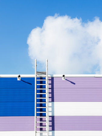 Cloud in blue sky and ladder on a wall