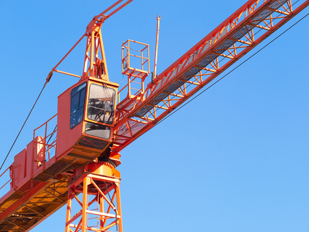 Hoisting crane. Fragment against the blue sky.の写真素材