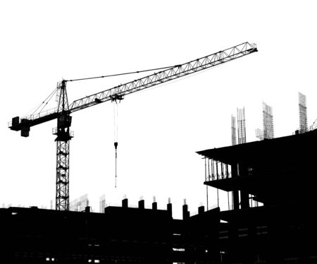 Silhouettes of a construction crane and building on a white backgroundの写真素材