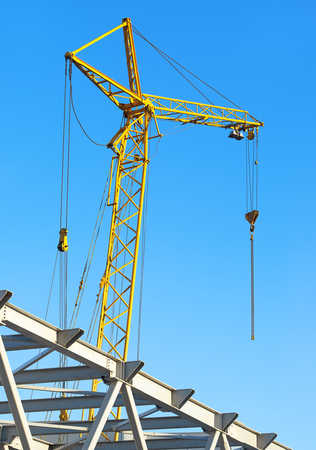 hoisting crane against the blue skyの写真素材