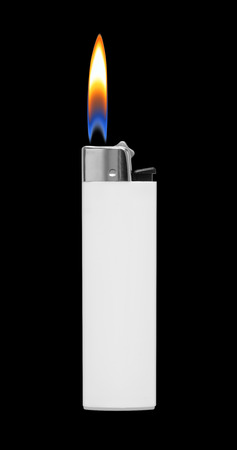 Lighter with fire on black backgroundの写真素材