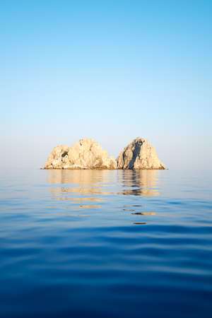 rocks in the sea on a background of clear skyの写真素材