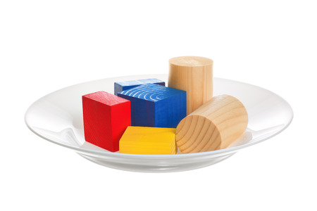 Genetically modified food. Plate with colored objects on a white background. の写真素材