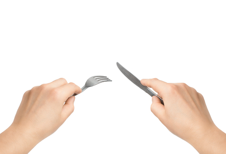 hands with knife and fork on a white background                             の写真素材