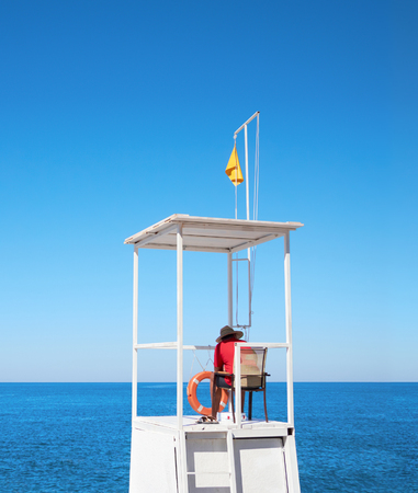Lifeguard on tower on the background of sky and seaの写真素材