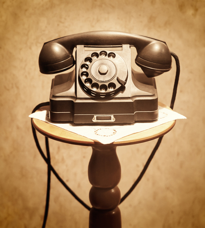 vintage telephone on a small tableの写真素材