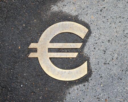 euro sign on wet asphaltの写真素材