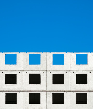 Fragment of a building under construction against a blue sky, abstract background.の写真素材