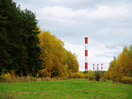 Industrial pipes among autumn natureの写真素材