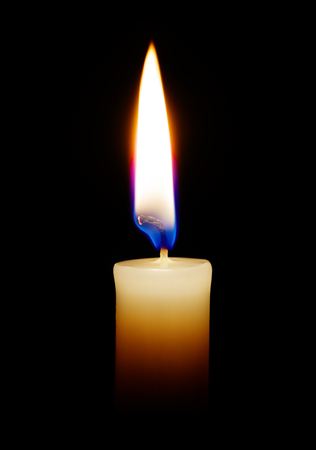 Burning candle on a black background closeupの写真素材